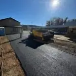 a man standing next to a road