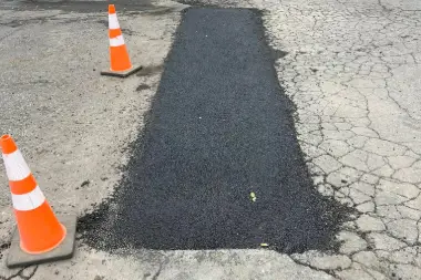 a road with a patch of asphalt