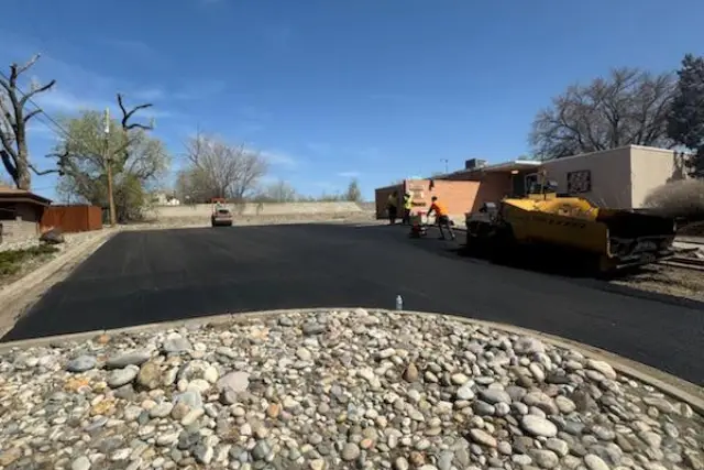 a road with a few construction equipment